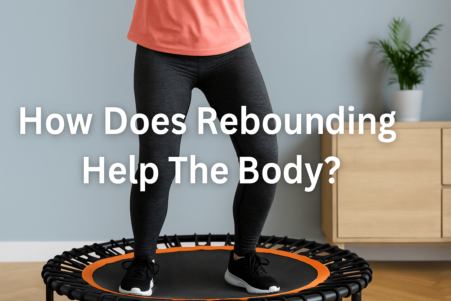 woman-bouncing-on-rebounder-trampolines-in-living-room-wearing-coral-top-and-black-leggings-smiling-active-fitness-workout