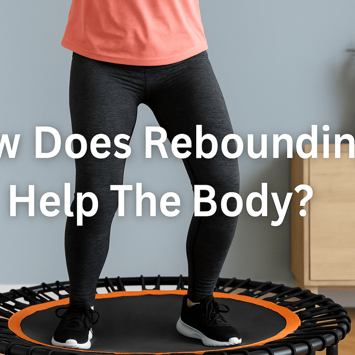 woman-bouncing-on-rebounder-trampolines-in-living-room-wearing-coral-top-and-black-leggings-smiling-active-fitness-workout