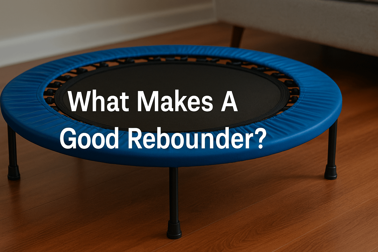 blue-rebounder-mini-trampoline-on-wooden-floor-with-text-what-makes-a-good-rebounder-centred-on-mat