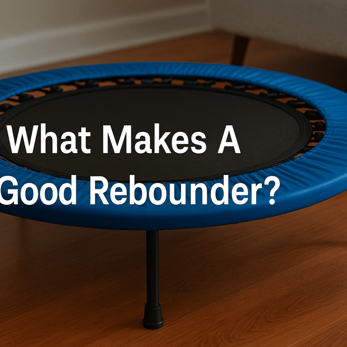blue-rebounder-mini-trampoline-on-wooden-floor-with-text-what-makes-a-good-rebounder-centred-on-mat