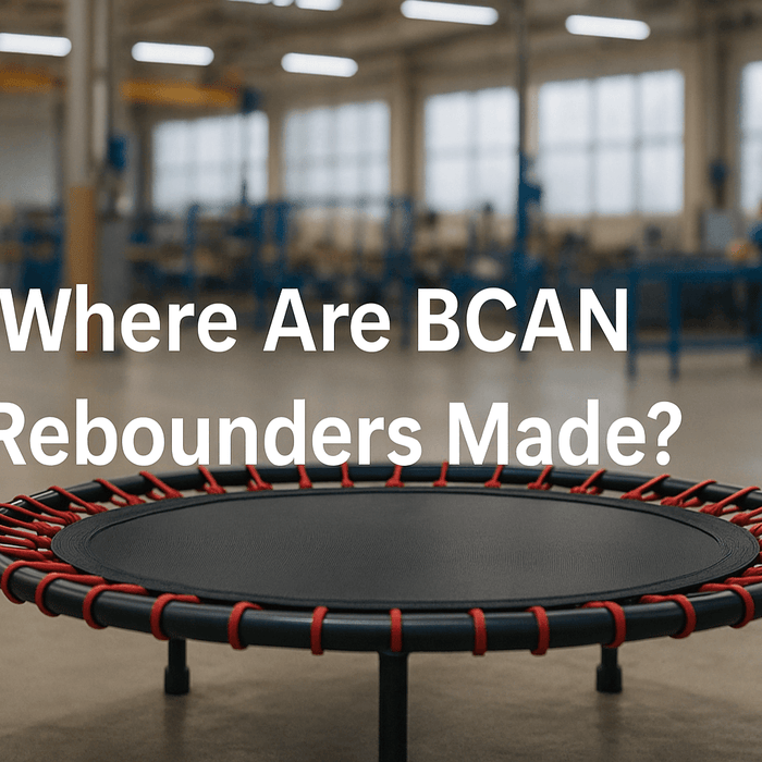 rebounders-trampoline-in-uk-factory-setting-showing-assembly-process-with-red-bungee-cords-and-black-frame-where-are-bcan-rebounders-made-text-centered