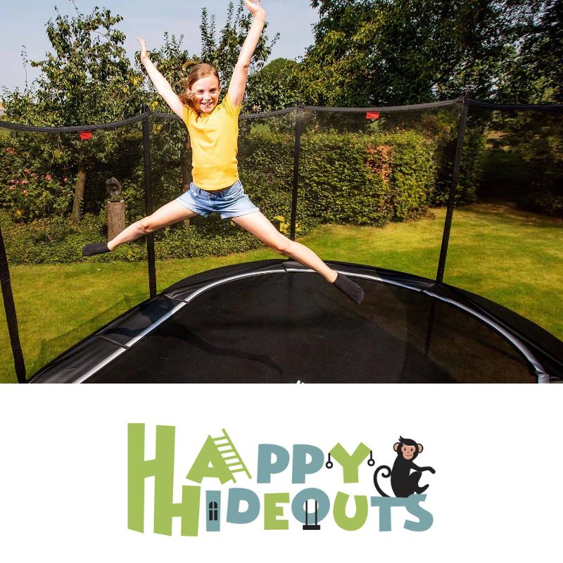 Garden-trampoline-with-net-jumping-in-garden-with-arms-up