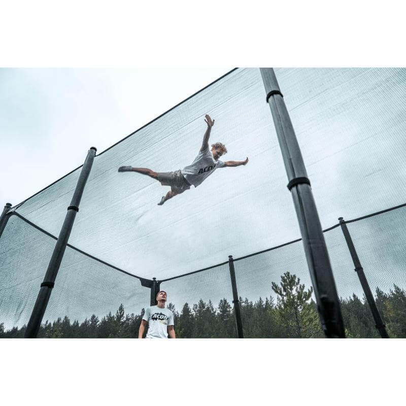 ACON-X-Trampoline-athlete-jumping-high-against-safety-net