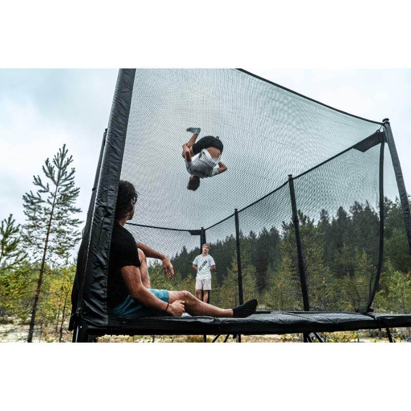ACON-X-Trampoline-child-flipping-above-safety-net-enclosure