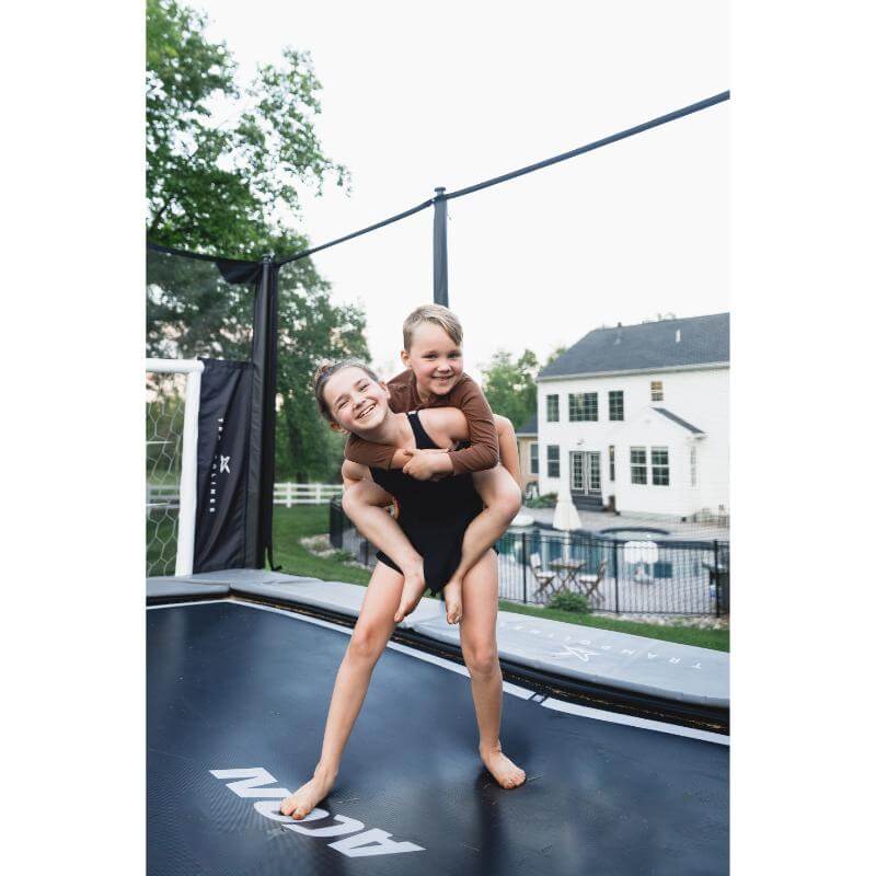 ACON-X-Trampoline-with-children-playing-on-backyard-jumping-mat
