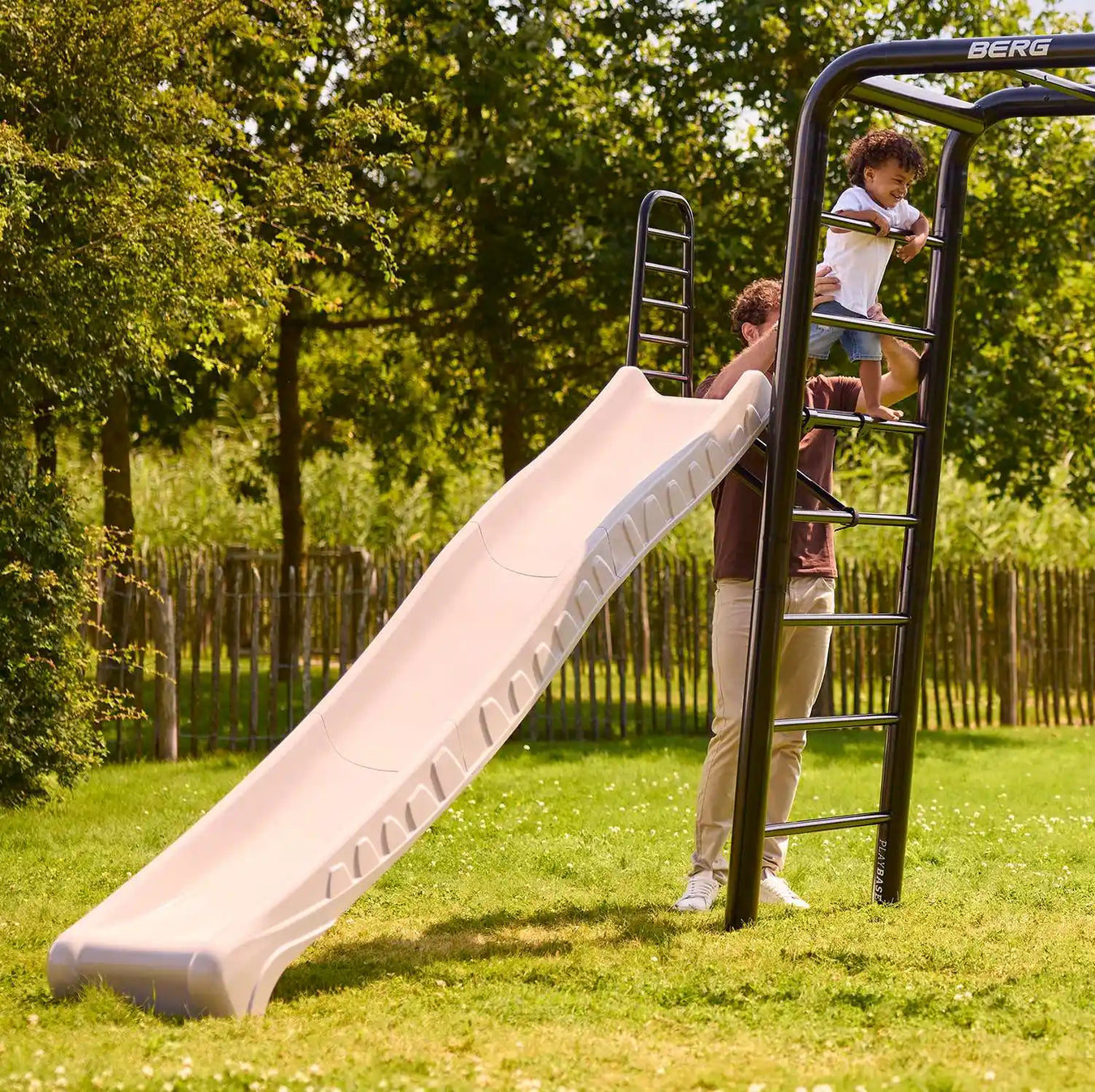 BERG Playbase Platform and Slide with dad and son in the garden playing