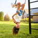 BERG Trapeze with girl hanging upside down