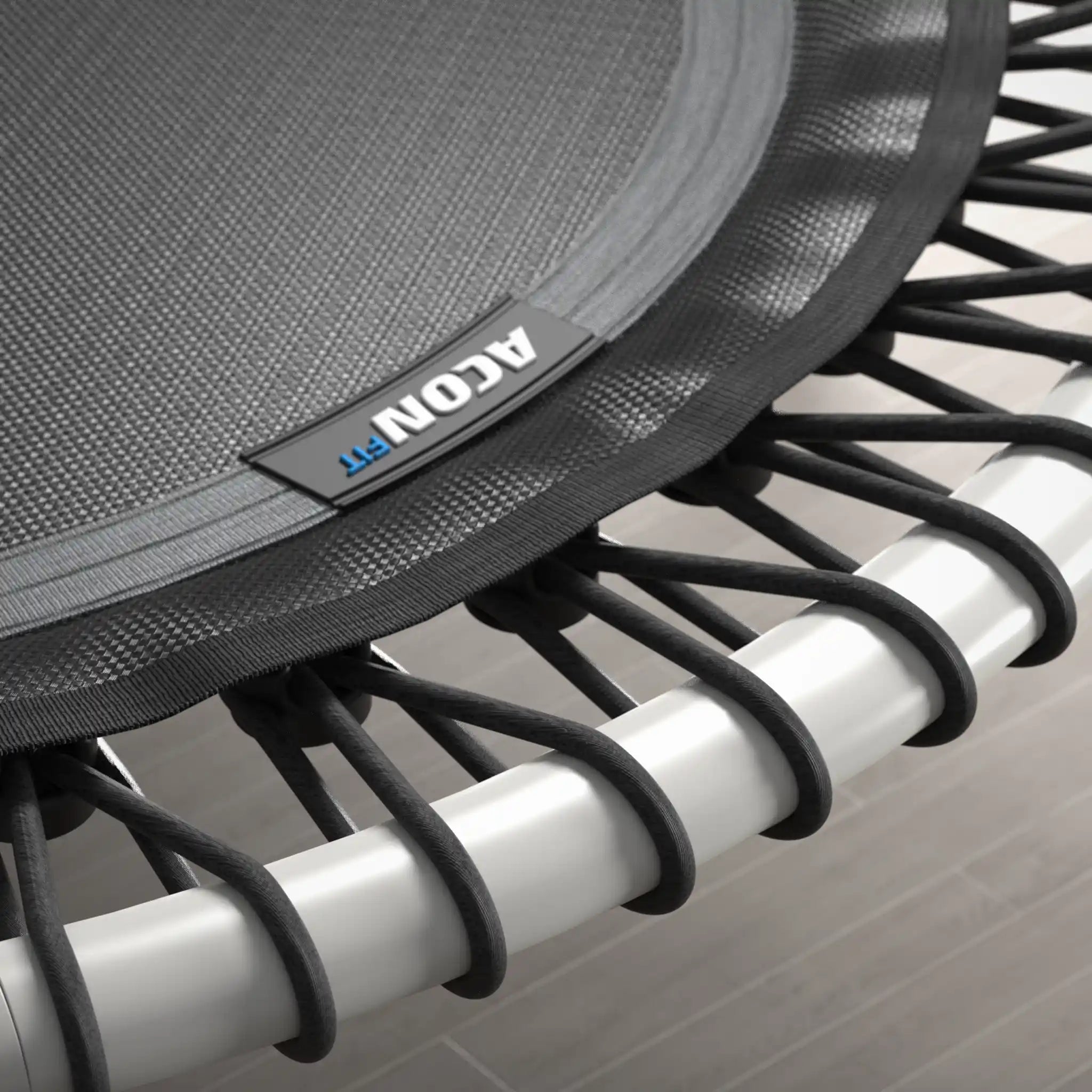Close-up of a white rebounder with  Acon branding on a gray background