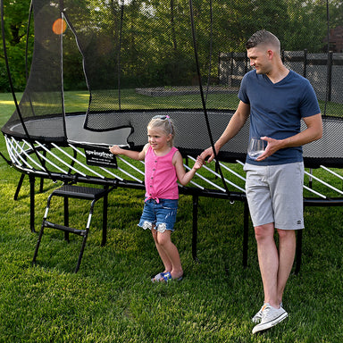 Springfree_Large_Oval_Trampoline_daughter_and_father_outside