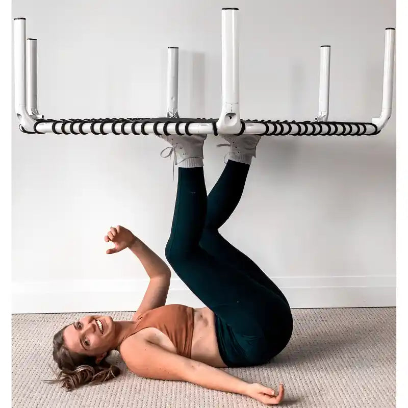 Woman-balancing-white-ACON-rebounder-on-her-feet-lying-down-inside