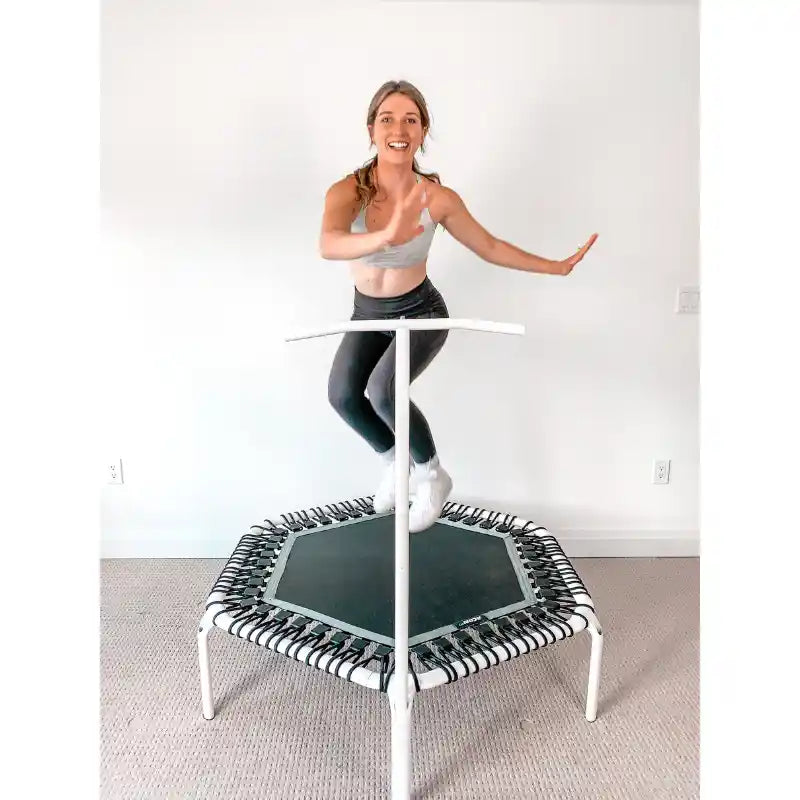 Woman-bouncing-on-white-ACON-rebounder-with-handle