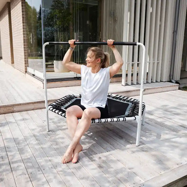 Woman-leaning-on-white-ACON-rebounder-on-patio