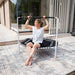 Woman-leaning-on-white-ACON-rebounder-on-patio