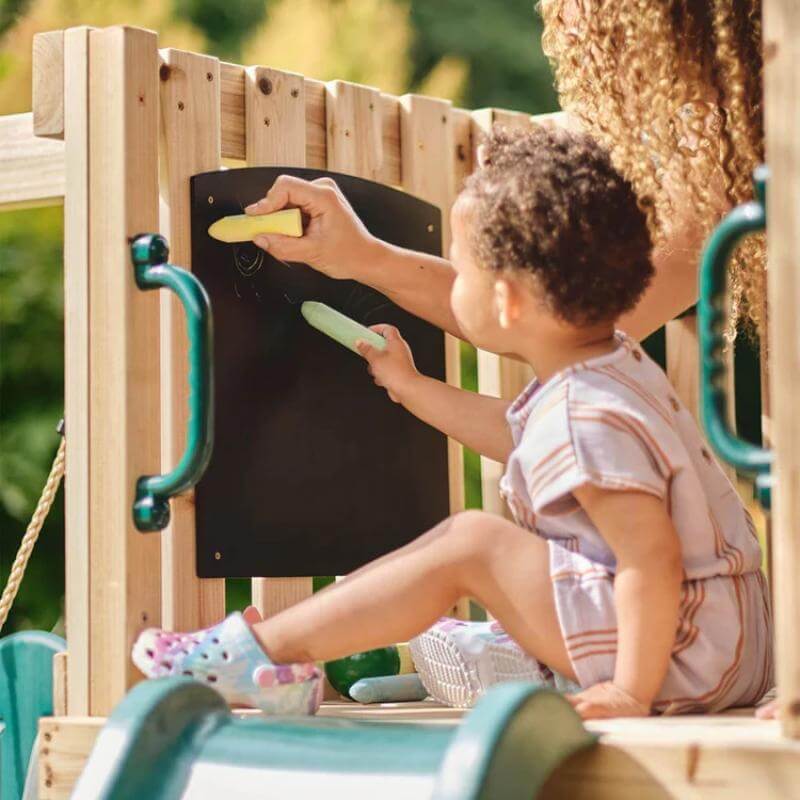 adult-and-toddler-drawing-on-chalkboard-inside-wooden-playcentre