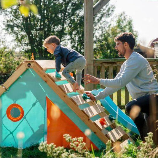 adult-helping-child-climb-wooden-ramp-on-triangular-playcentre