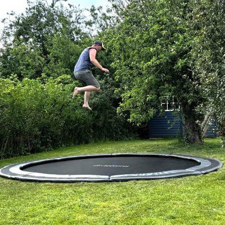 adult-jumping-on-north-14ft-round-inground-trampoline