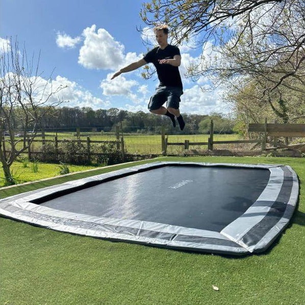 adult-jumping-on-north-17ft-x-12ft-rectangular-inground-trampoline