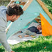 adult-looking-into-triangular-play-tent-with-child-lying-inside-on-cushions
