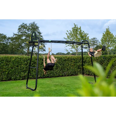 adult-swinging-exit-MB305-monkeybar-lifestyle-shot-with-bush-in-the-background