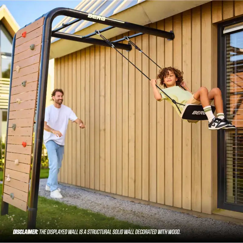 berg-playbase-wall-swing-use-along-wall-with-father-and-son-enjoying-the-swing