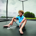 berg-ultim-elite-16ft-x-10ft-trampoline-with-boy-sitting-on-jump-mat