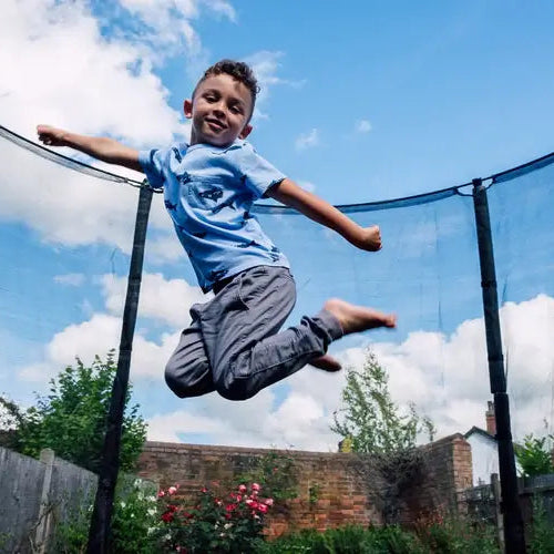 boy-jumping-inside-plum-spacezone-trampoline-low-angle-view