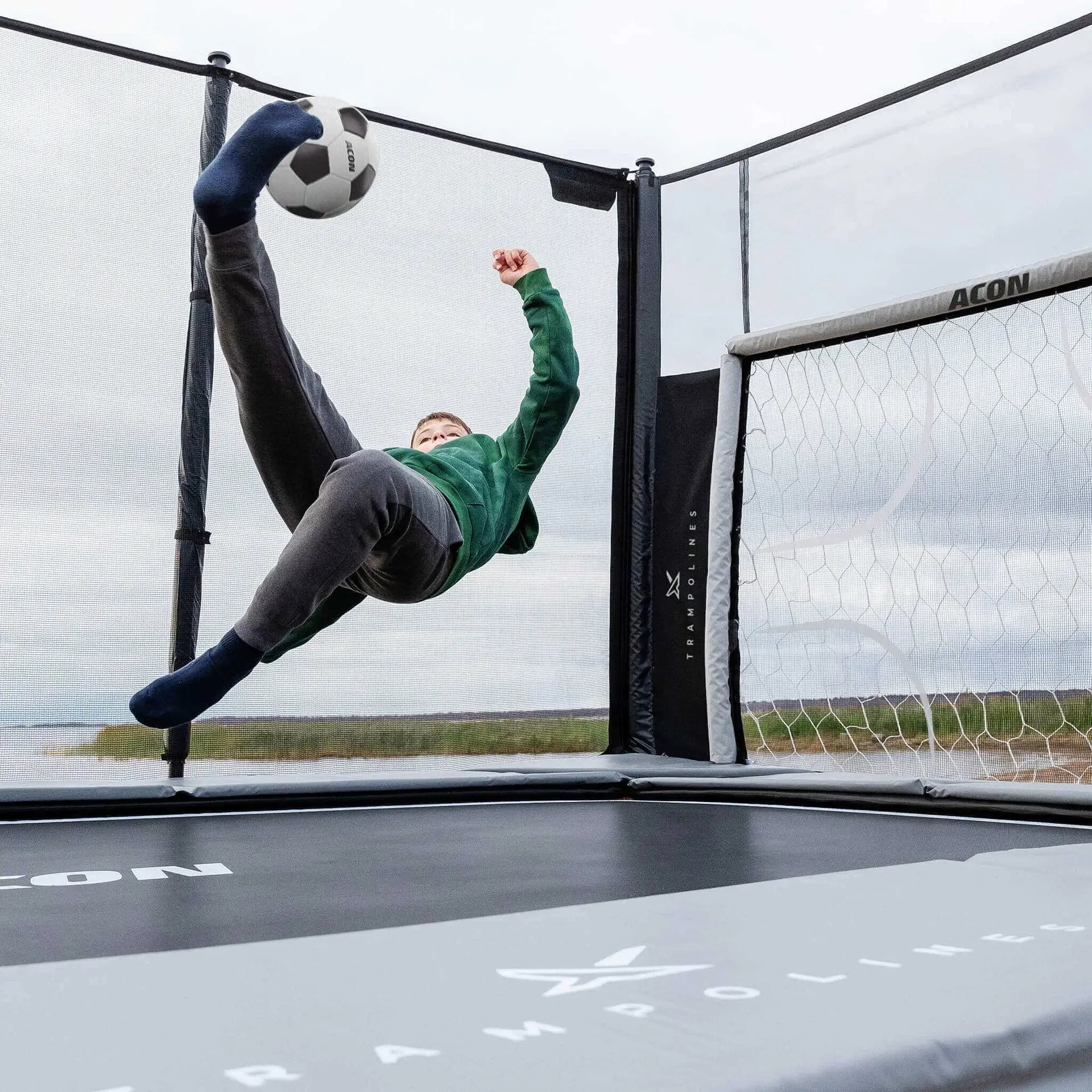 boy-kicks-acon-trampoline-soccer-goal-panel-outside-setup