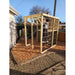 child-climbing-rope-net-on-wooden-climbing-cube-in-back-garden