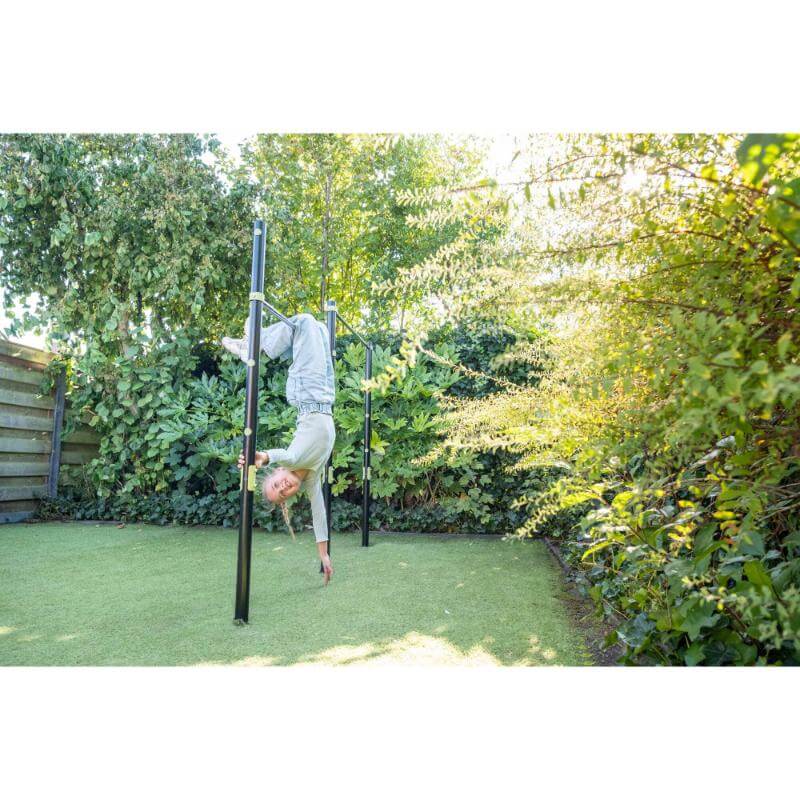 child-doing-gymnastics-on-exit-ivy-double-tumble-bar-in-garden