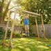 child-hanging-from-wooden-monkey-bars-in-garden