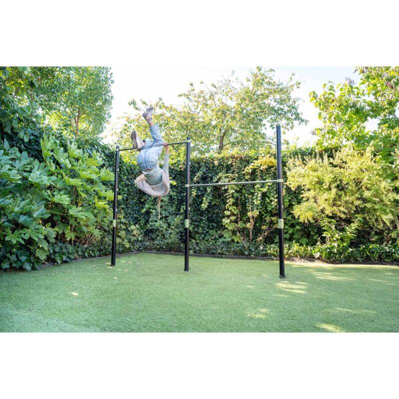 child-hanging-upside-down-on-exit-ivy-double-tumble-bar-in-garden