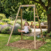 child-laughing-on-plum-play-wooden-single-swing-frame