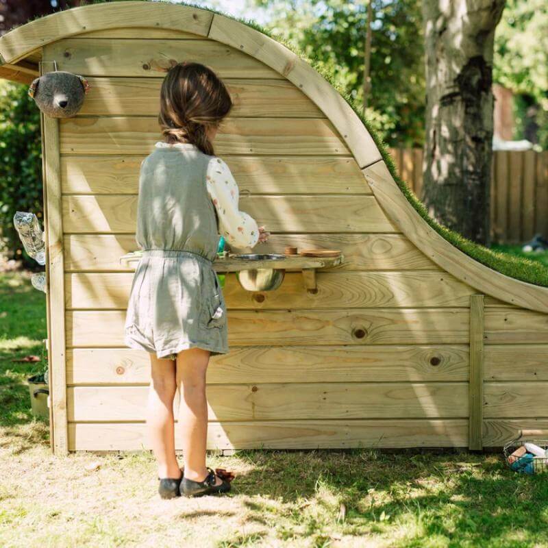 child-playing-at-side-shelf-of-plum-discovery-nature-play-hideaway