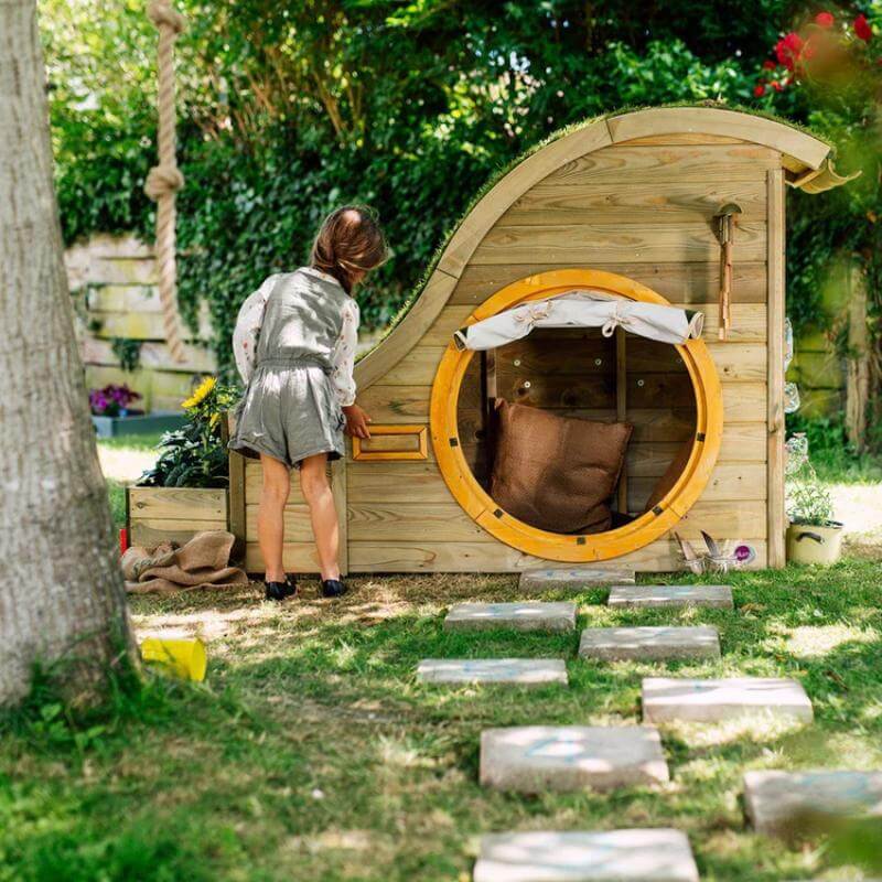 child-playing-beside-plum-discovery-nature-play-hideaway-in-garden