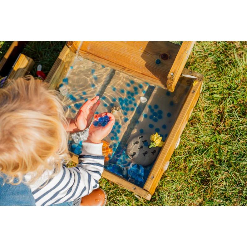 child-playing-with-blue-water-beads-in-lower-collection-tray-of-wooden-water-run