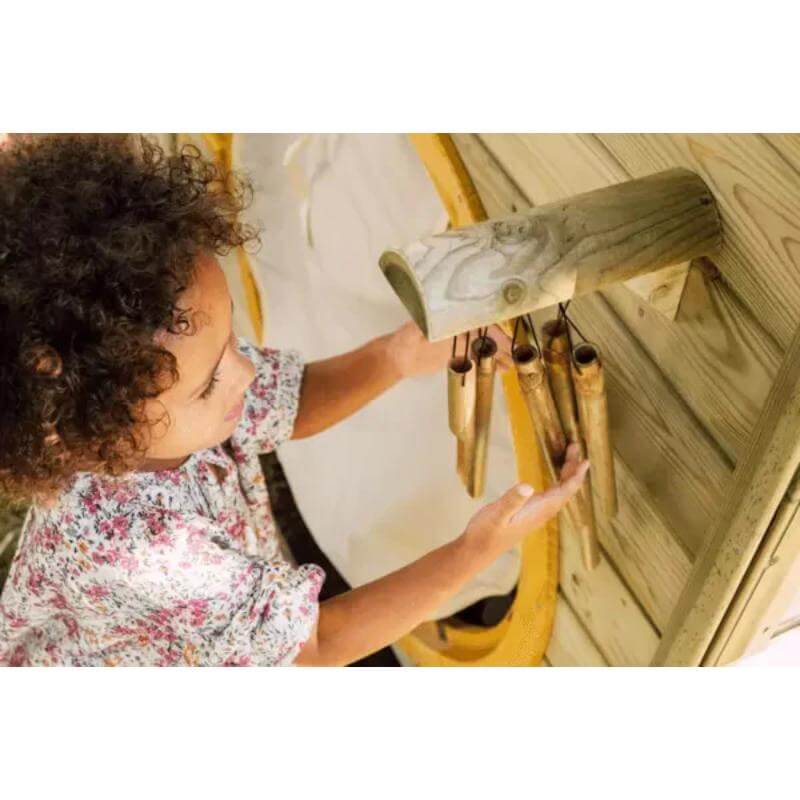 child-playing-with-wind-chimes-on-plum-discovery-nature-play-hideaway