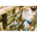child-pouring-water-through-bottles-on-plum-discovery-mud-pie-kitchen