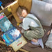 child-resting-on-cushions-with-books-and-soft-toy-under-wooden-playcentre