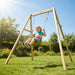 child-riding-exit-toys-silvi-wooden-swing-frame-in-backyard