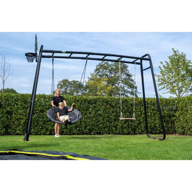 lifestyle-shot-of-a-child-riding-nest-swing-in-exit-MB305-monkeybar-with-wooden-swing-attached