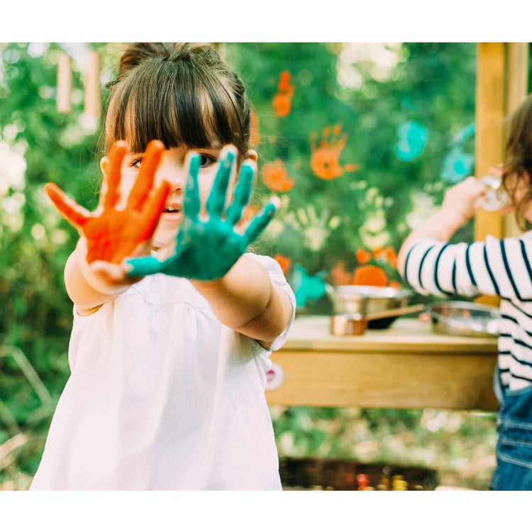 child-showing-painted-hands-at-plum-discovery-mud-pie-kitchen