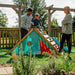 child-sitting-at-top-of-triangular-playcentre-ramp-with-two-adults-standing-nearby