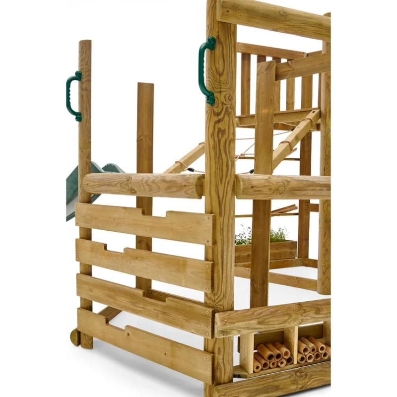 child-sliding-down-large-green-slide-on-wooden-adventure-playcentre