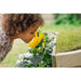 child-smelling-flowers-in-planter-on-plum-discovery-nature-play-hideaway