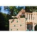 child-standing-at-the-top-of-a-plum-wooden-rock-climbing-wall-extension-main