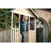 child-standing-on-exit-kids-wooden-playhouse-300-with-slide