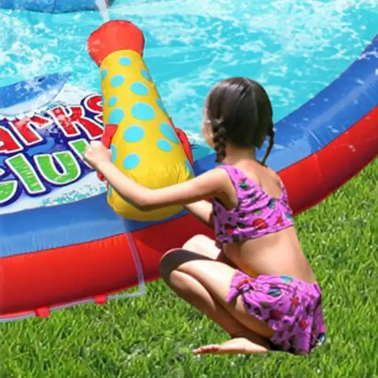 child-using-water-cannon-on-inflatable-shark-splash-slide