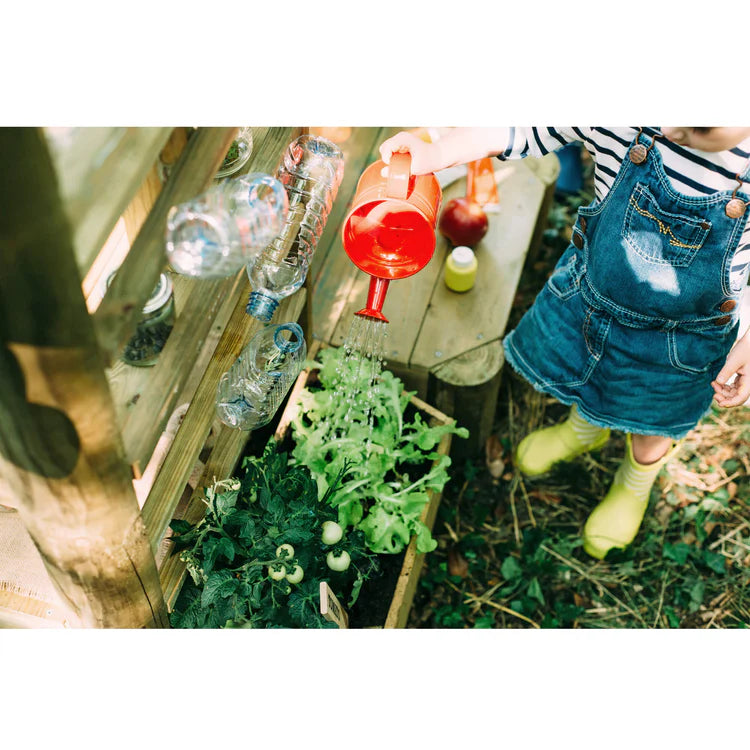 child-watering-planter-at-plum-discovery-mud-pie-kitchen