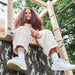 children-playing-inside-camo-den-under-wooden-climbing-cube