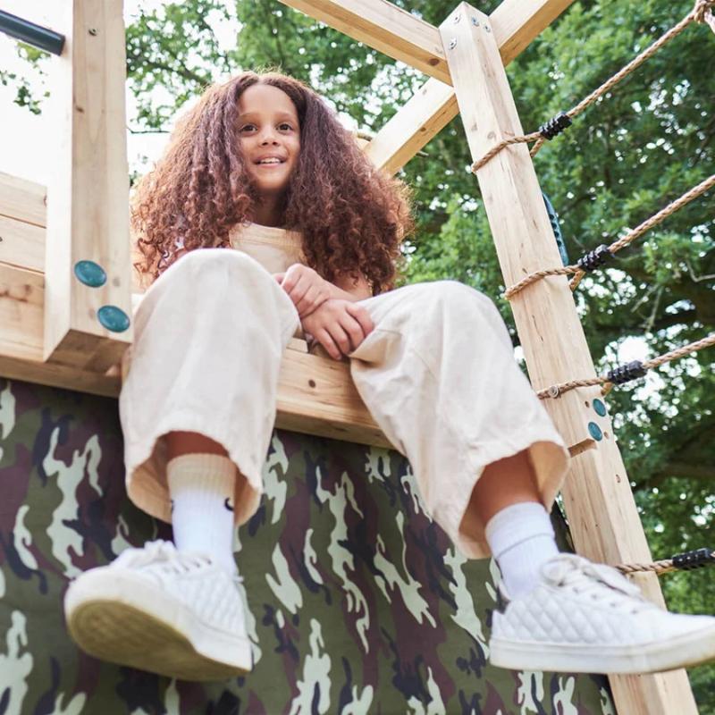 children-playing-inside-camo-den-under-wooden-climbing-cube